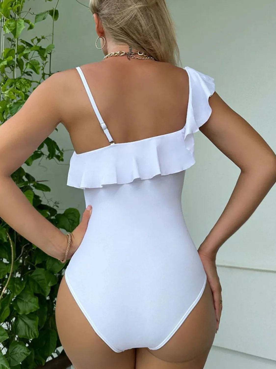 Back view of one-piece swimsuit with asymmetrical cut and stretch fit