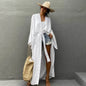 Lifestyle shot of Women's Belted Breeze Kimono Cover-Up at a tropical resort white color 