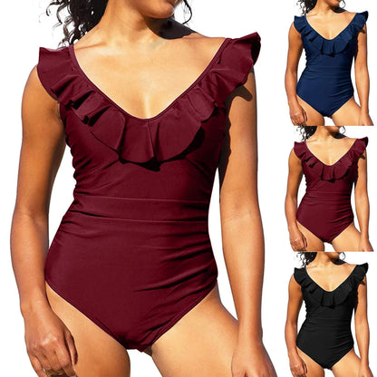 Model wearing solid color monokini with ruffle trim and tummy control