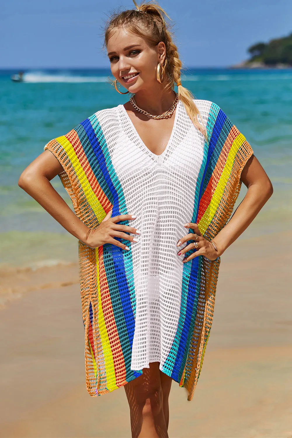Model wearing knit cover up over bikini at the beach     