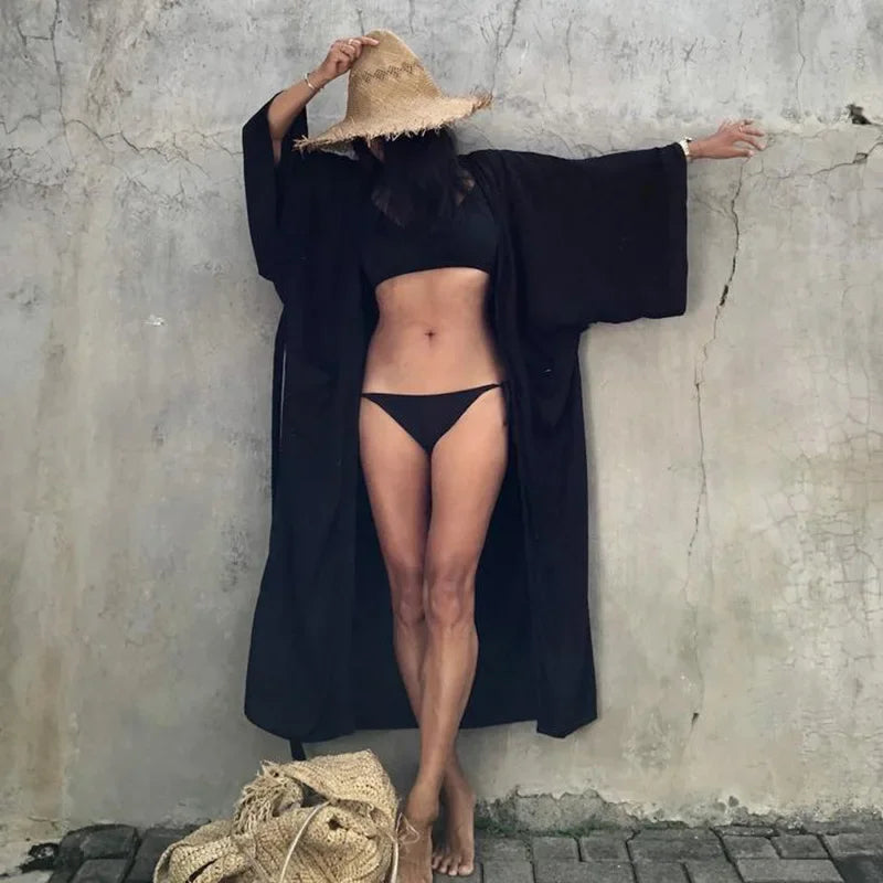 Lifestyle shot of Women's Belted Breeze Kimono Cover-Up at a tropical resort