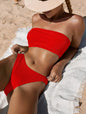 Lifestyle banner featuring high-waist bandeau bikini on the beach
