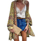 Flat lay of Women's Bohemian Floral Long-Sleeve Cardigan Cover-Up with beach essentials