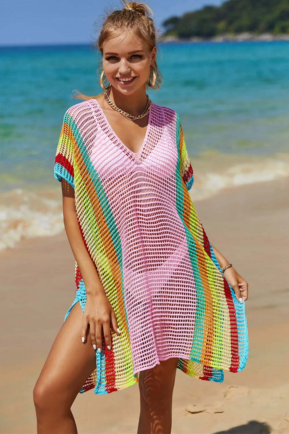Model wearing knit cover up over bikini at the beach 