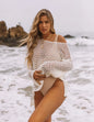 Model wearing Women's Mesh Glow Knitted Sweater Cover-Up on a tropical beach