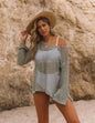 Flat lay of Women's Mesh Glow Knitted Sweater Cover-Up with beach essentials