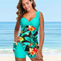 Lifestyle shot of woman in floral swimdress walking on beach with cover-up